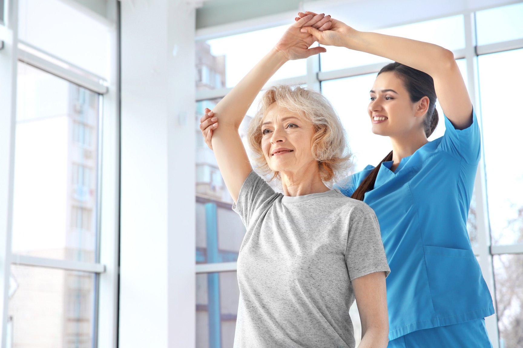 Physiotherapist Working with Elderly Patient in Clinic