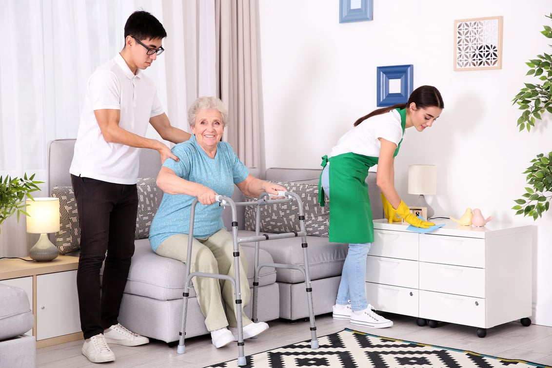 Senior Woman with Young Caregivers at Home